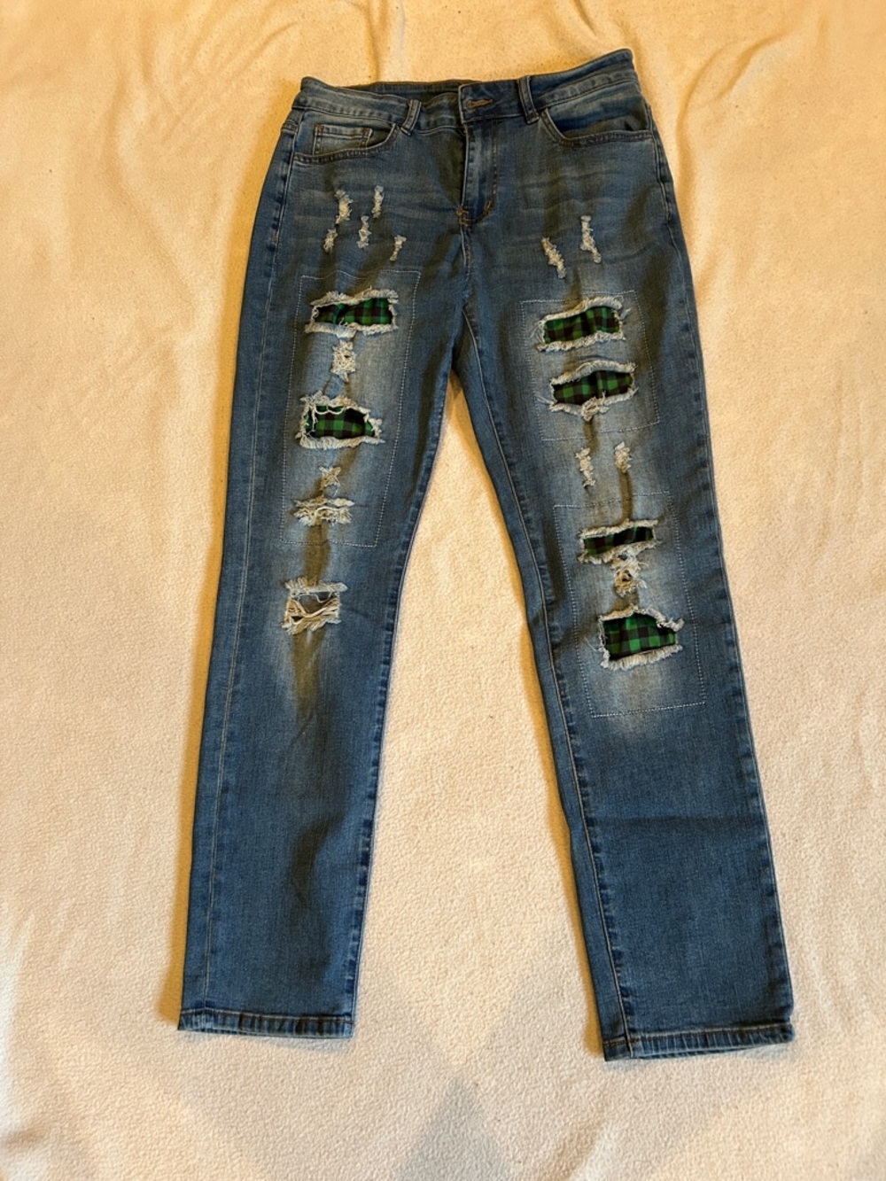 A Stylish Women's Blue Jeans with Green Plaid Patch